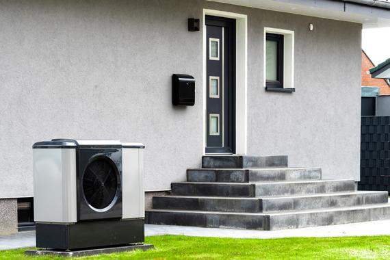 Wärmepumpe vor saniertem Haus